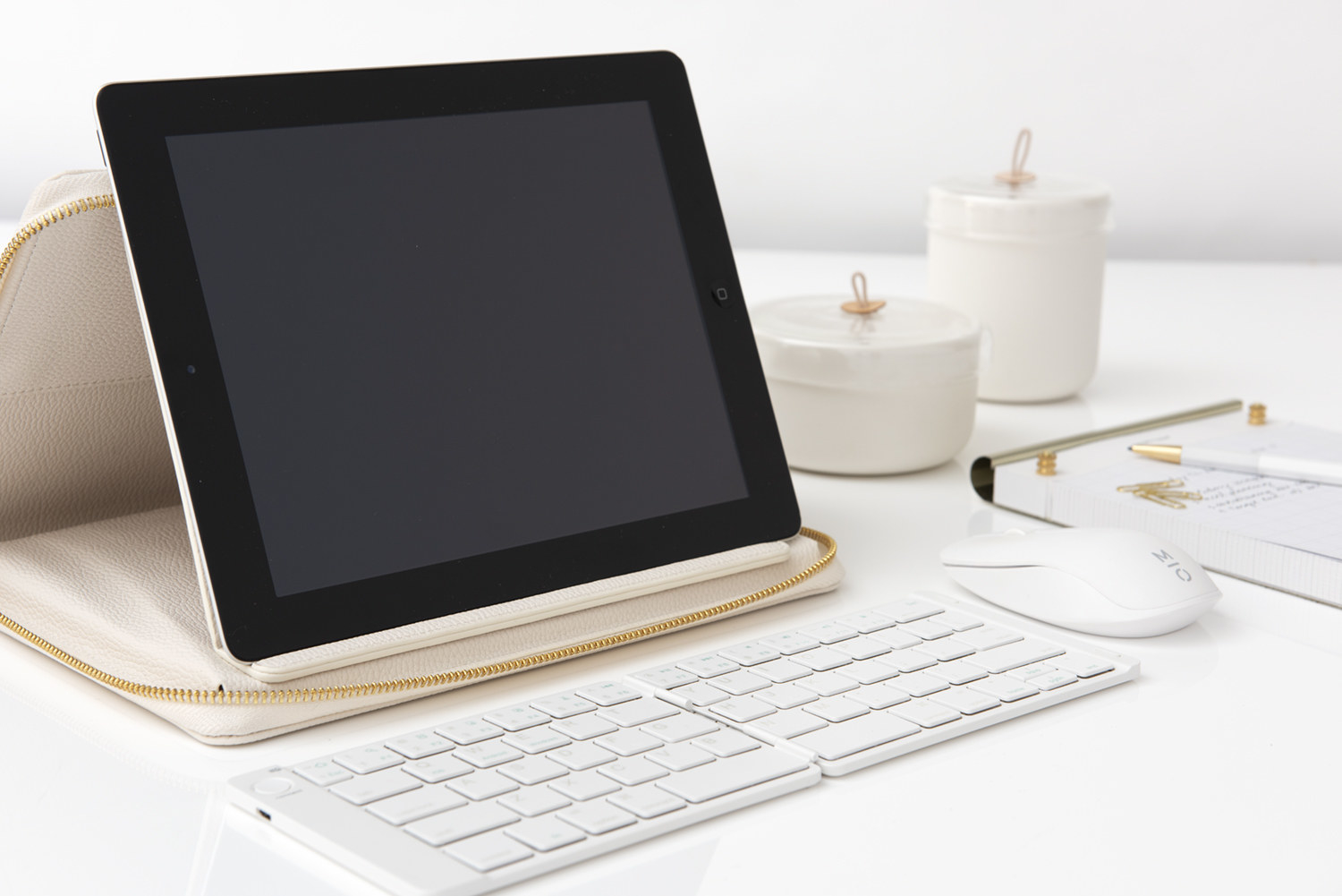 white bluetooth keyboard being used with an iPad