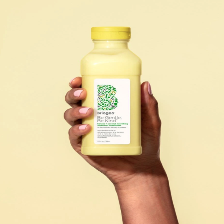 hand holding the bottle of conditioner 