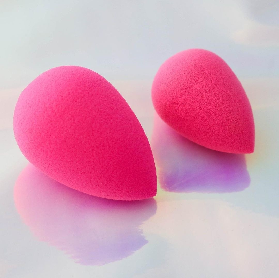 Two small makeup sponges of different sizes on a counter top