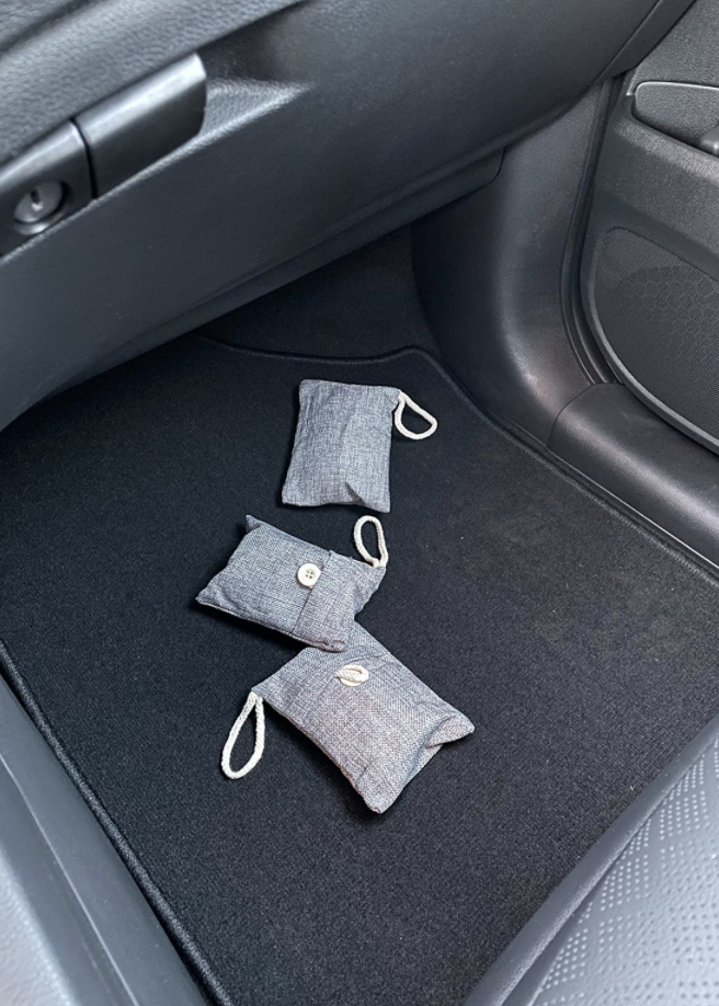 bamboo charcoal purifying bags on floor of reviewer's car