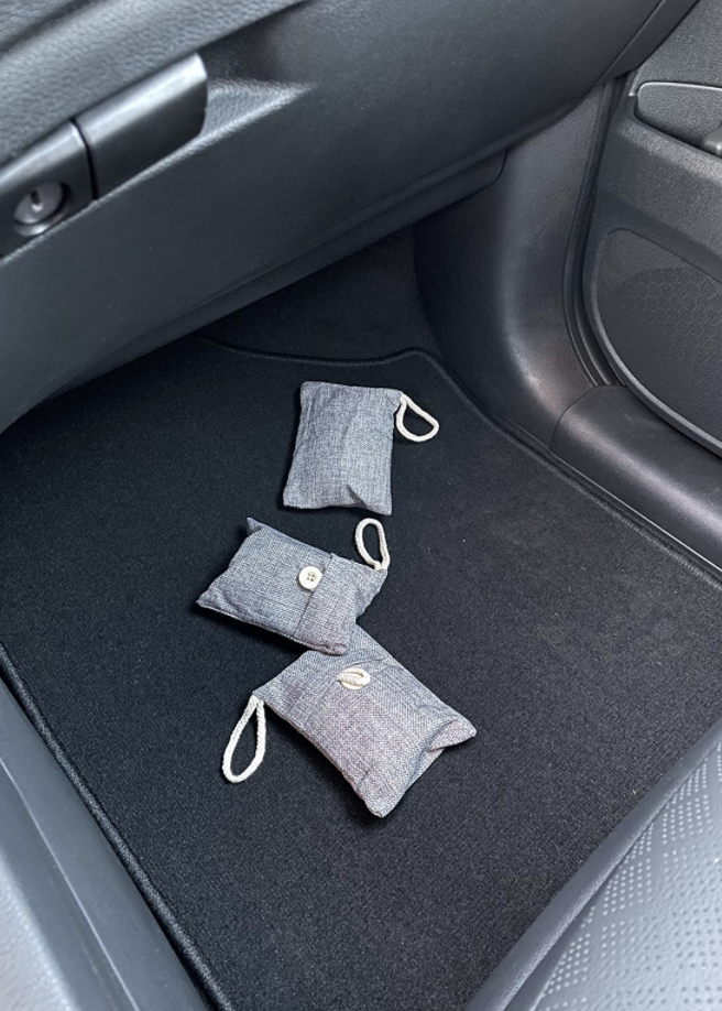 bamboo charcoal purifying bags on floor of reviewer&#x27;s car 