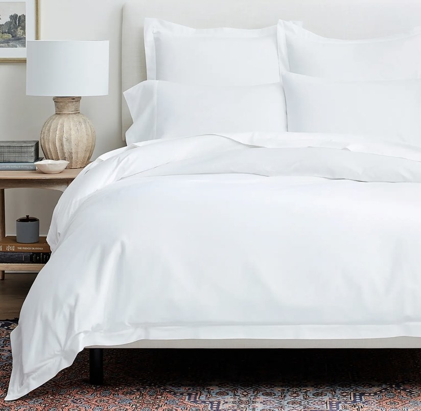 the sheet set in white on a bed