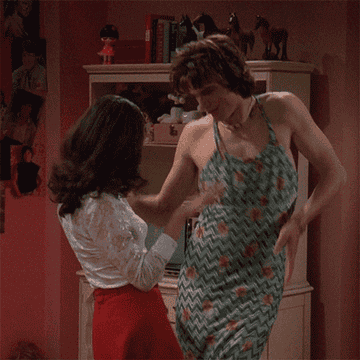 Jackie (Mila Kunis) and Kelso (Ashton Kutcher) dancing together at home 