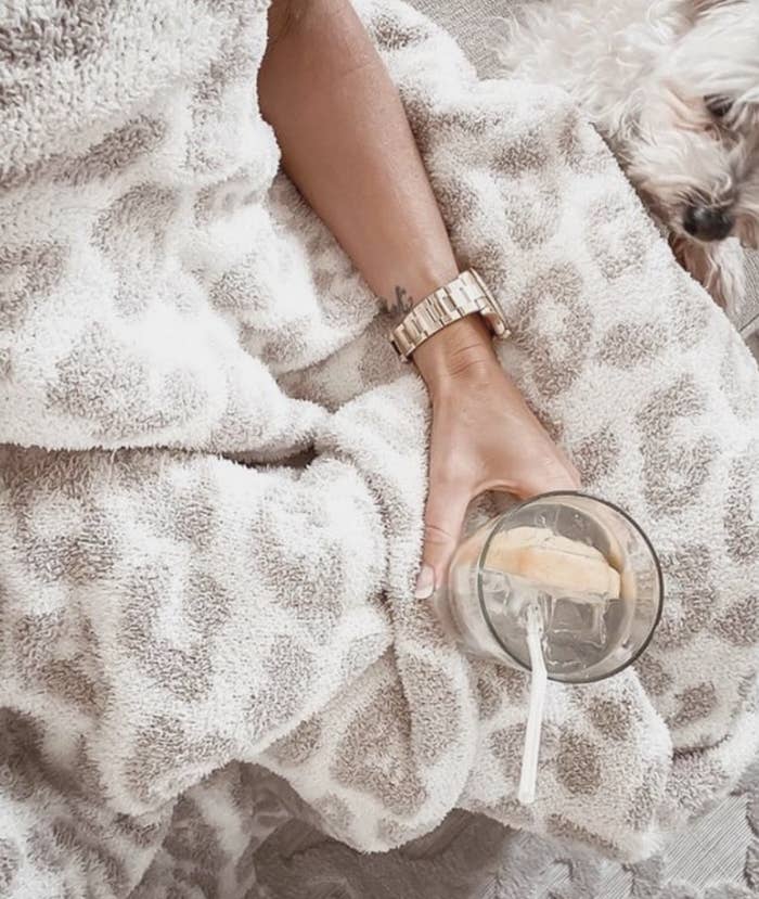 The fuzzy blanket in a grey and white leopard print pattern