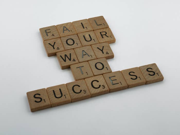 The words, &quot;Fail your way to success,&quot; spelled out with scrabble tiles.