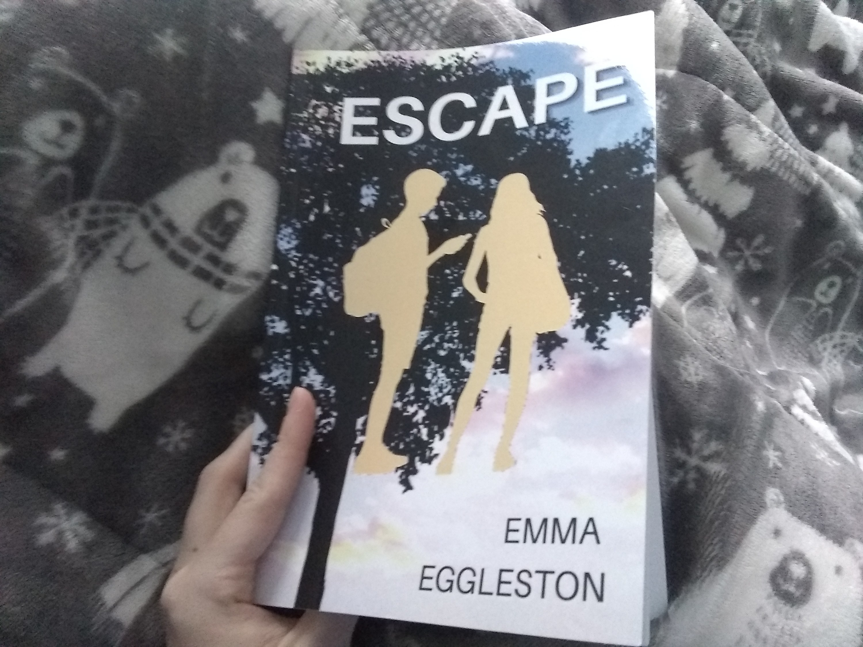 A woman&#x27;s hands opening the book, Escape, by Emma Eggleston.