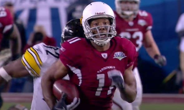 Larry Fitzgerald running with football.