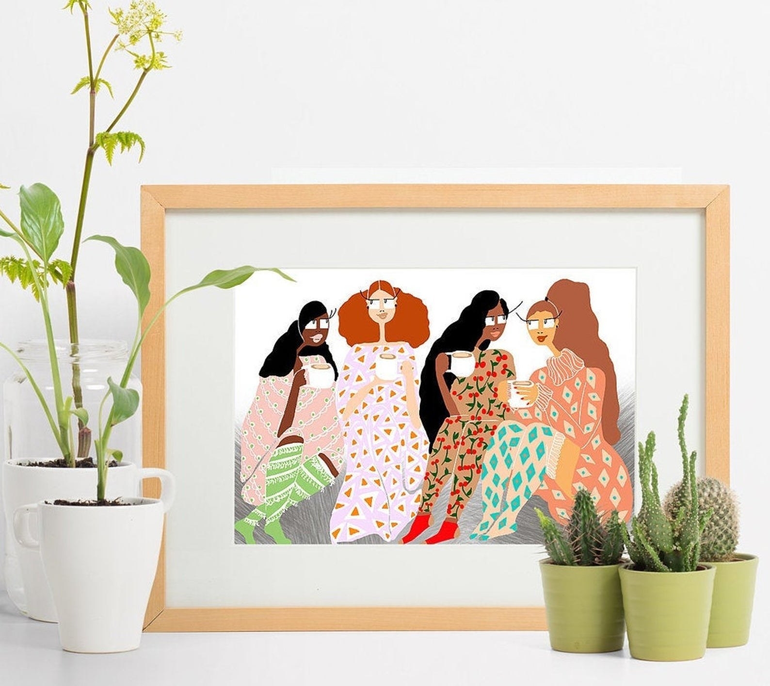 the rectangle art print with illustrations of four people sitting together with coffee cups in their hands