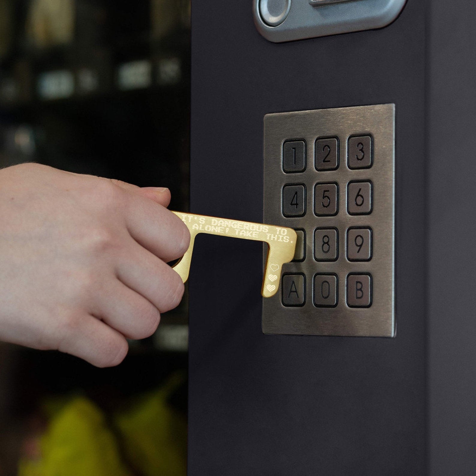a gold key-like tool with the words "it's dangerous to go alone! take this" on it