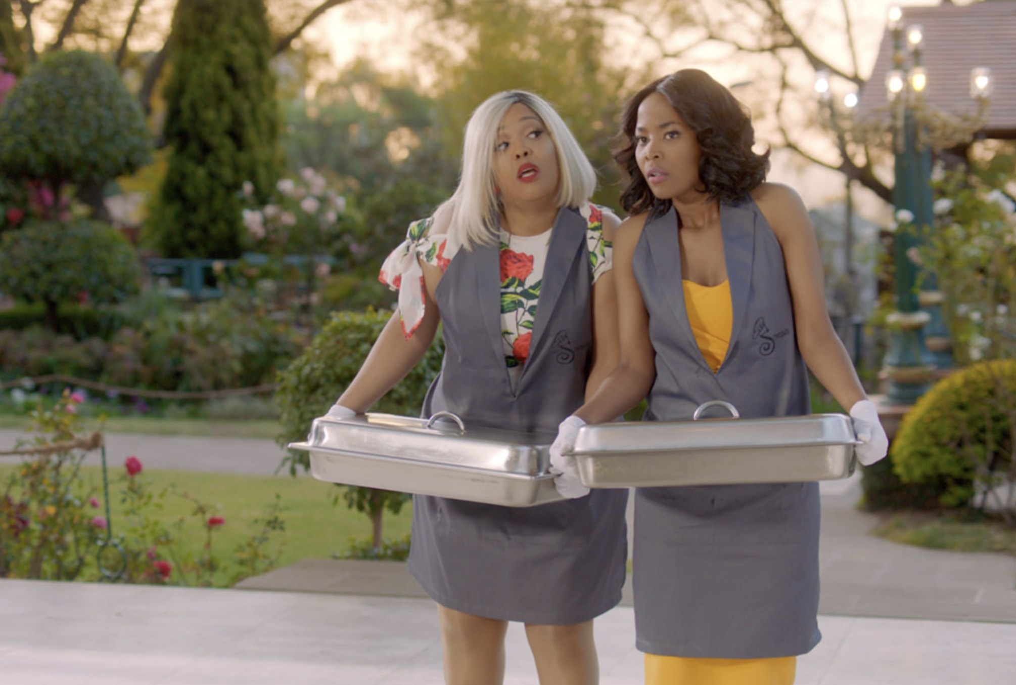 Dineo and Noni holding casseroles