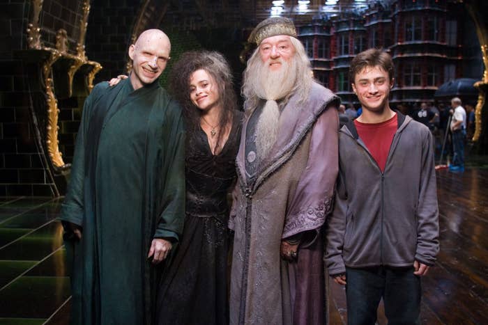the actors for Voldemort, Bellatrix, Dumbledore, and Harry posing and smiling on the set of the 5th film