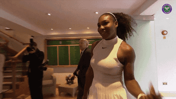 Serena Wiliams bobs her head while walking towards the Wimbledon championships winners board