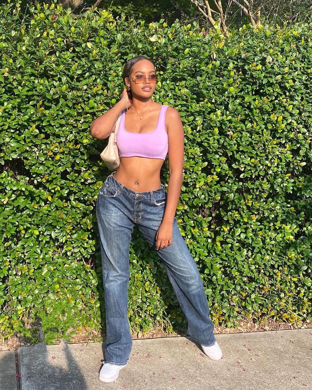 Maya Echols posing in jeans and a tank-top