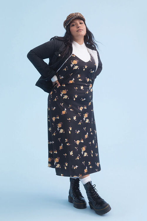 model wearing floral dress with white tee underneath, and a black jacket and boots