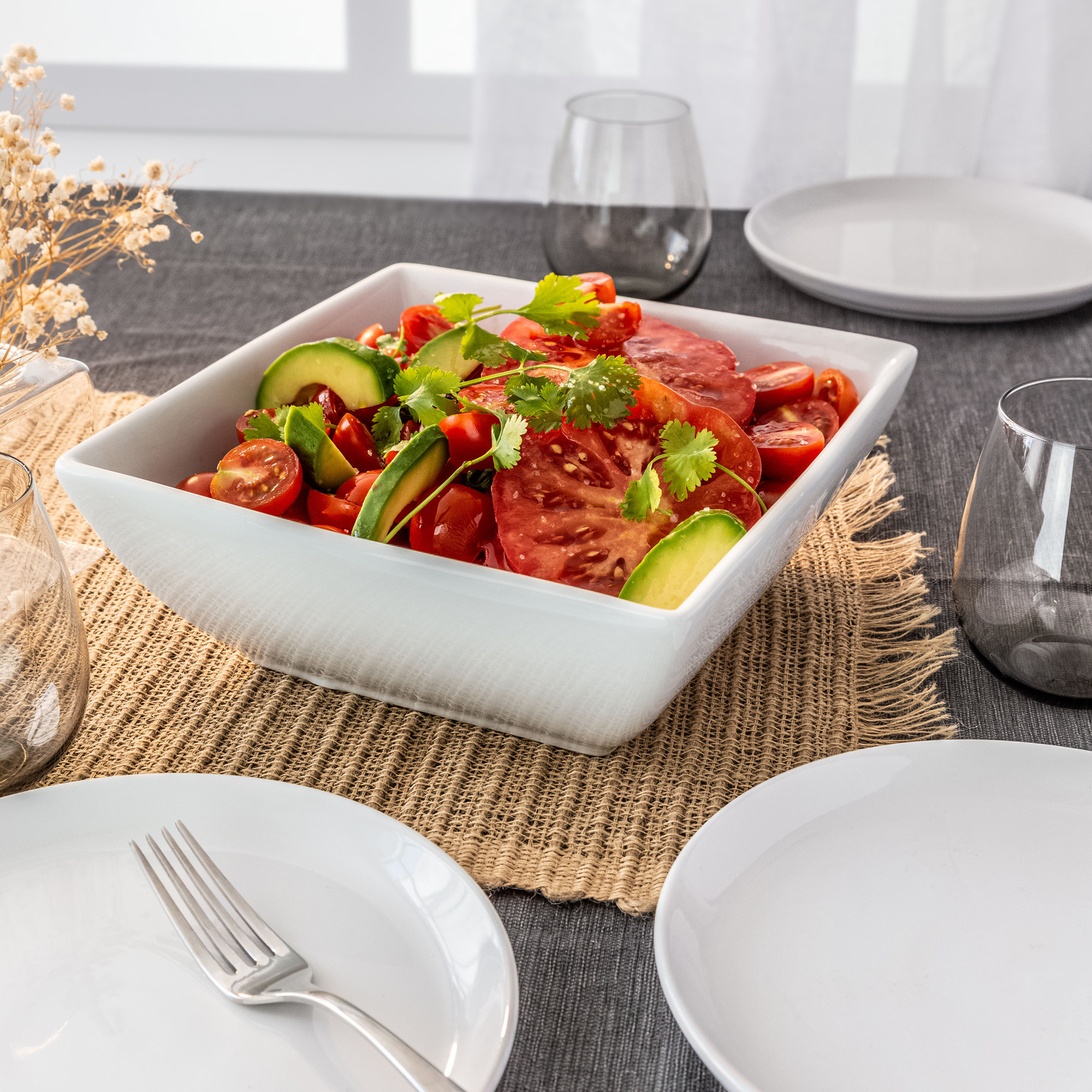 white square serving bowl with tomatoes on a table