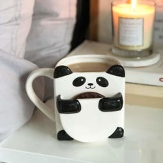 A panda mug with a cookie 
