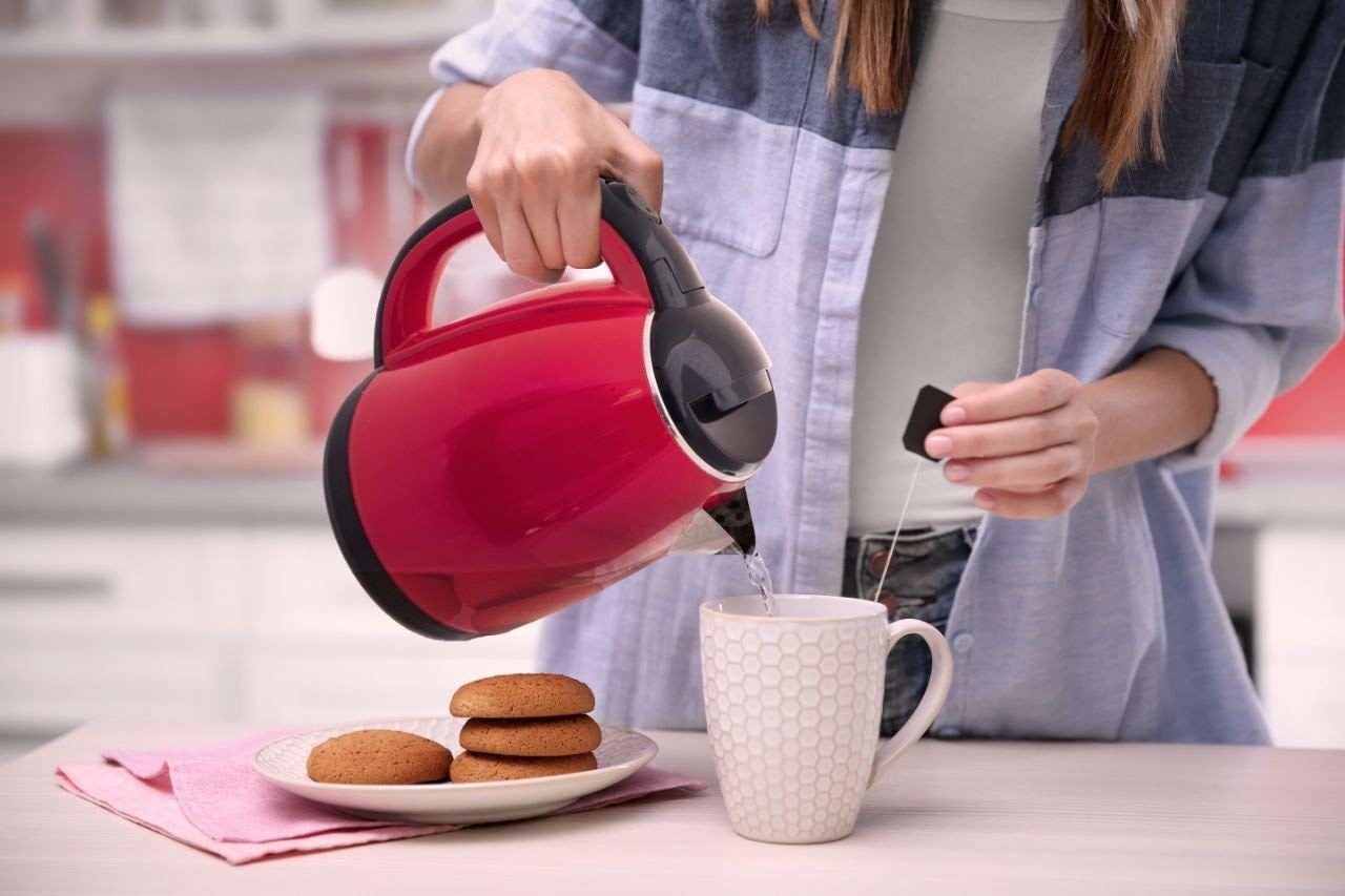 A kettle with water being poured into it 