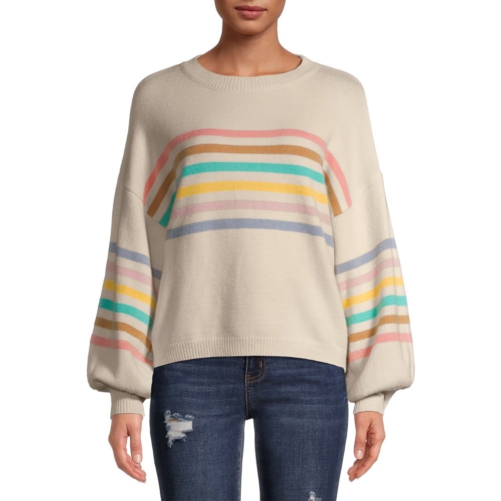 Model in rainbow striped puff sleeve sweater