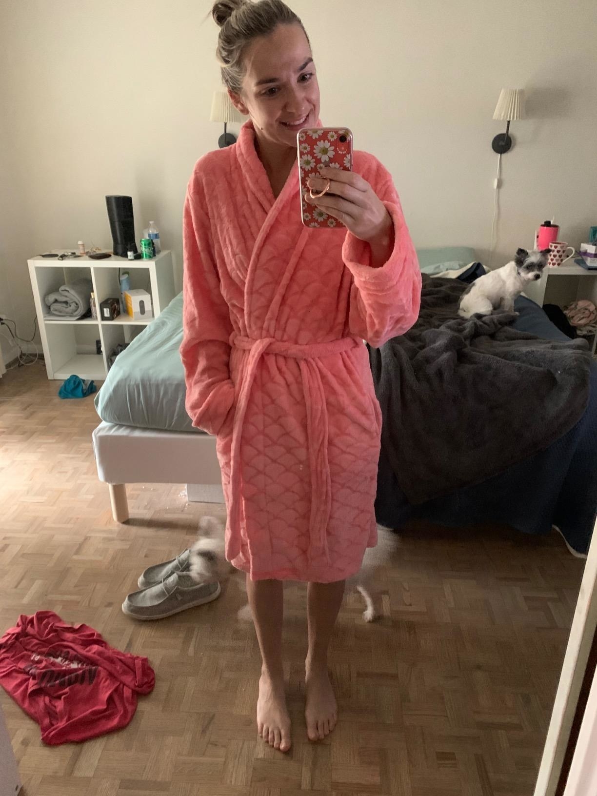 a reviewer in a pink plush robe