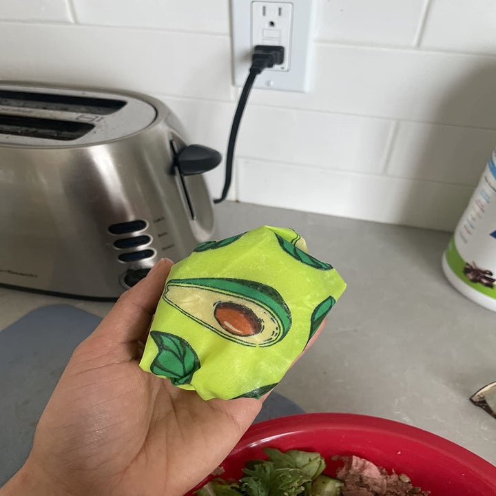 Reviewer holding avocado wrapped in beeswax wrap