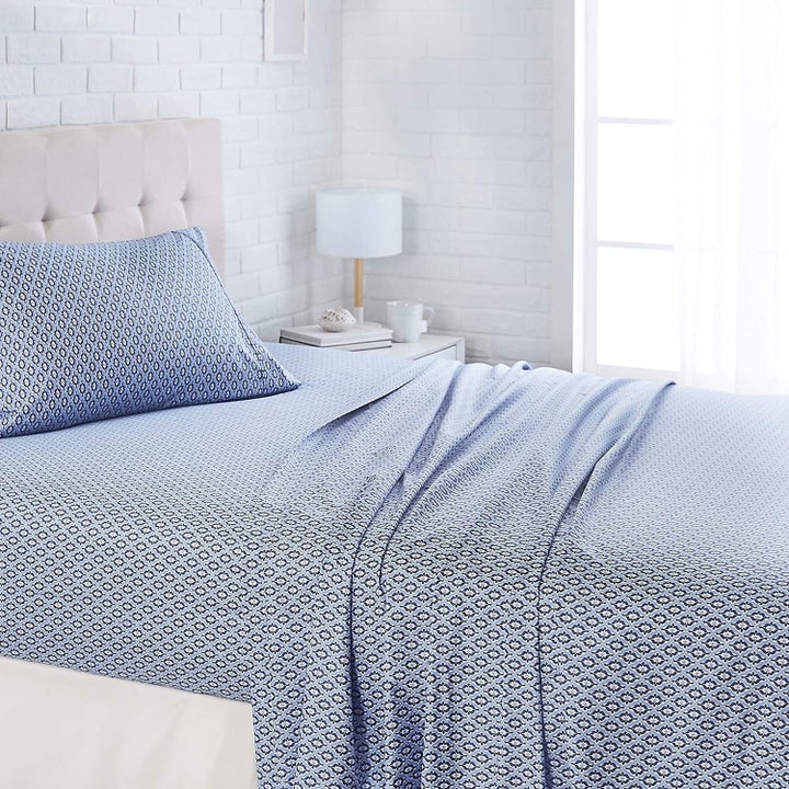 Bed with blue damask Amazon Basics sheets