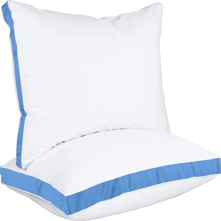 Two Utopia Bedding pillows with blue trim
