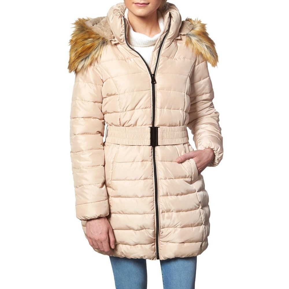 Model in ivory faux fur puffer coat