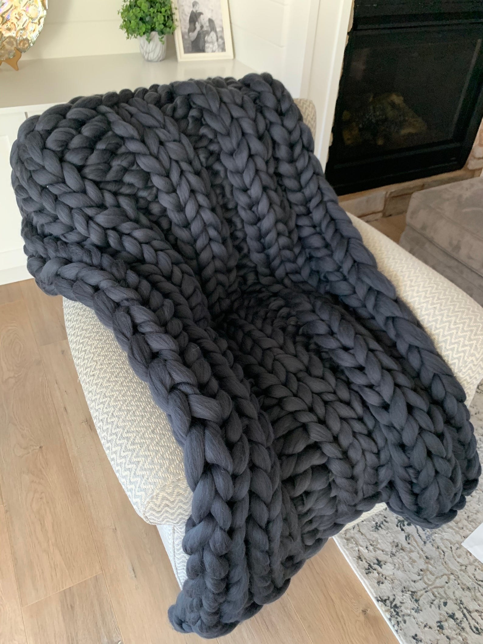 The gray knit blanket draped over a chair