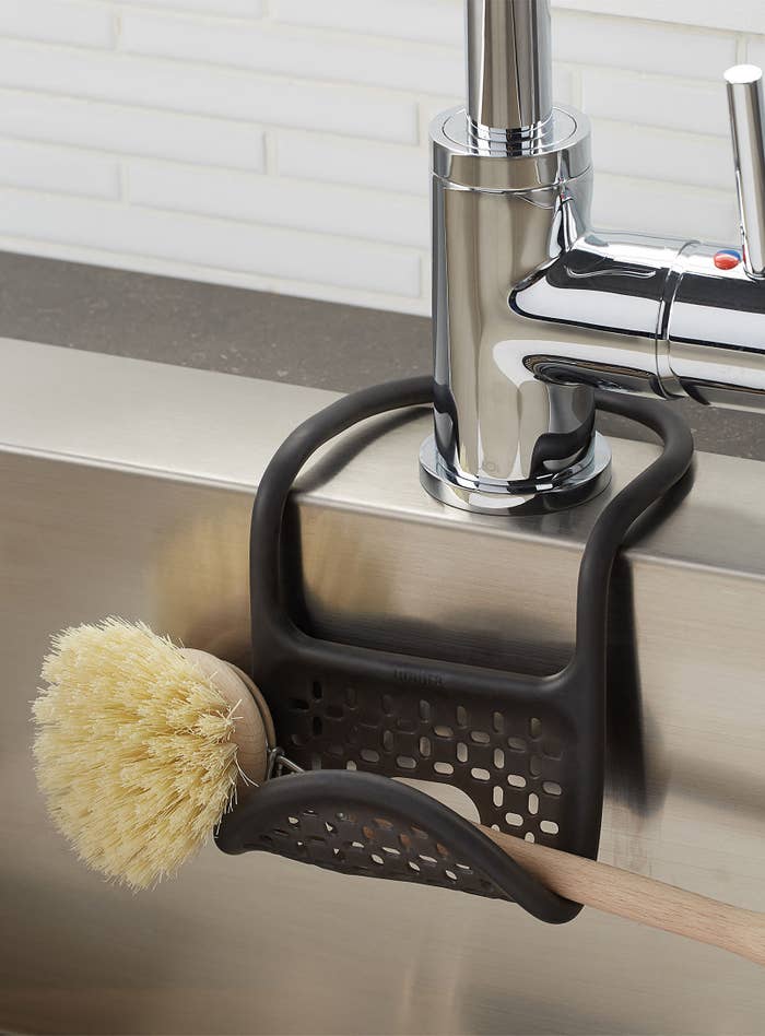 A small brush in a rubber sling hanging from the sink 