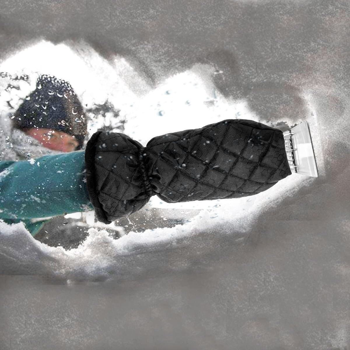 A model using the mitt to scrape snow off of a windshield