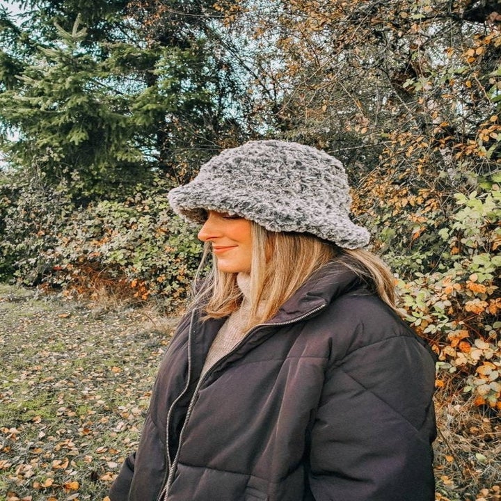 Side view of a model wearing the hat in grey