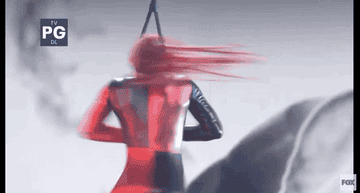 A woman spinning while hanging from her neck
