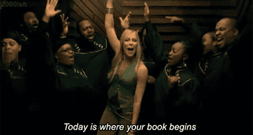 Natasha singing, &quot;Today is where your book begins&quot; as a choir jumps and sings around her in the &quot;Unwritten&quot; music video