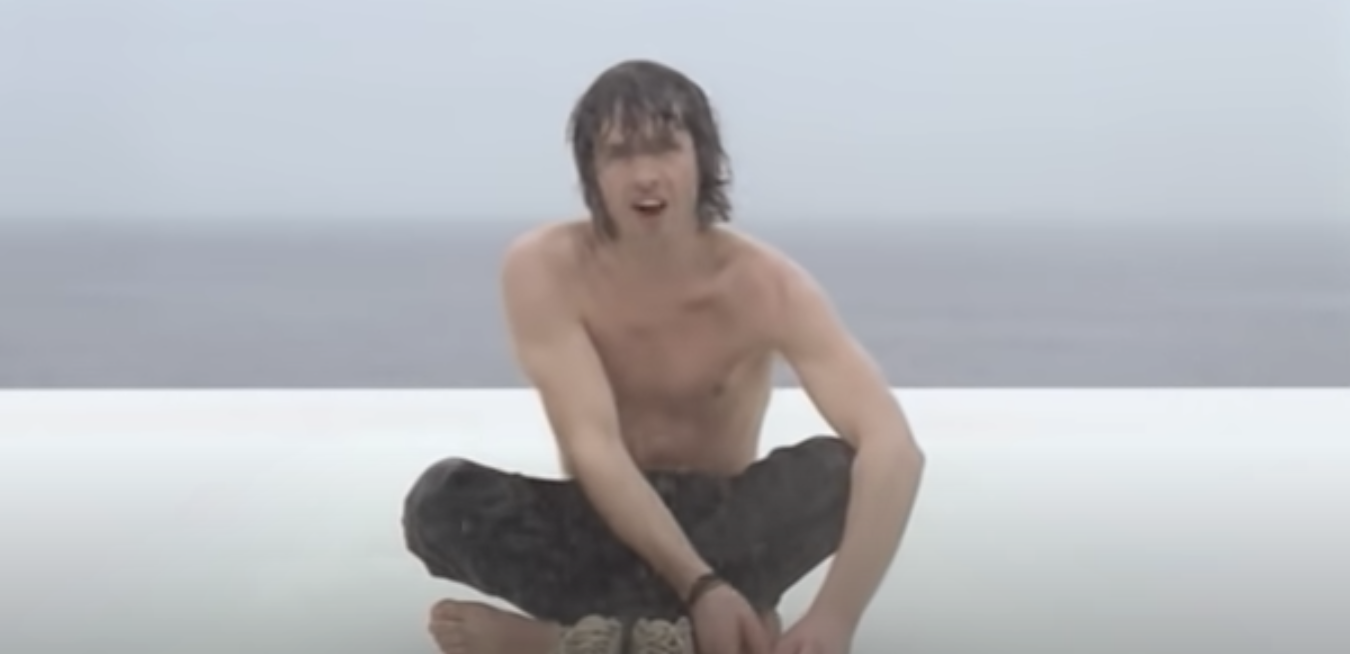 James sitting near the ocean in the &quot;You&#x27;re Beautiful&quot; video