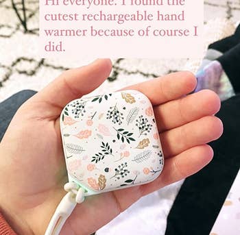 A reviewer holding the hand warmer in flower pattern