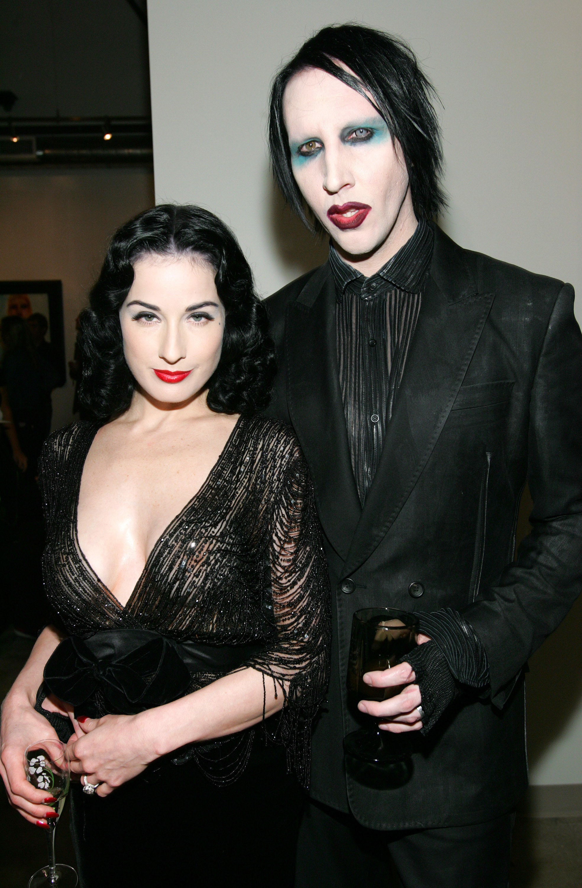 Dita Von Teese and Marilyn Manson stand next to each other.