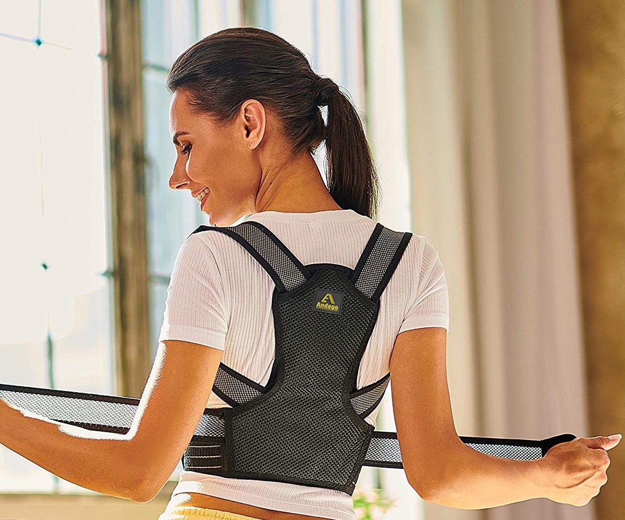 A person wearing the posture brace from the back 