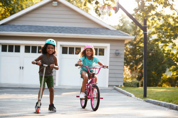 Kids playing on scooter.