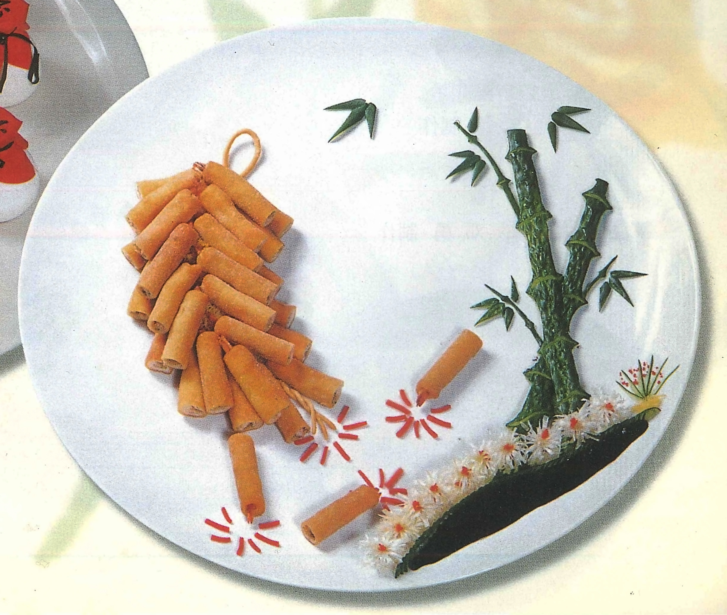 Spring rolls and bamboo are arranged on a plate to resemble Chinese fireworks and a landscape