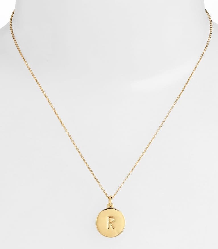 The pendant necklace, sporting the letter R