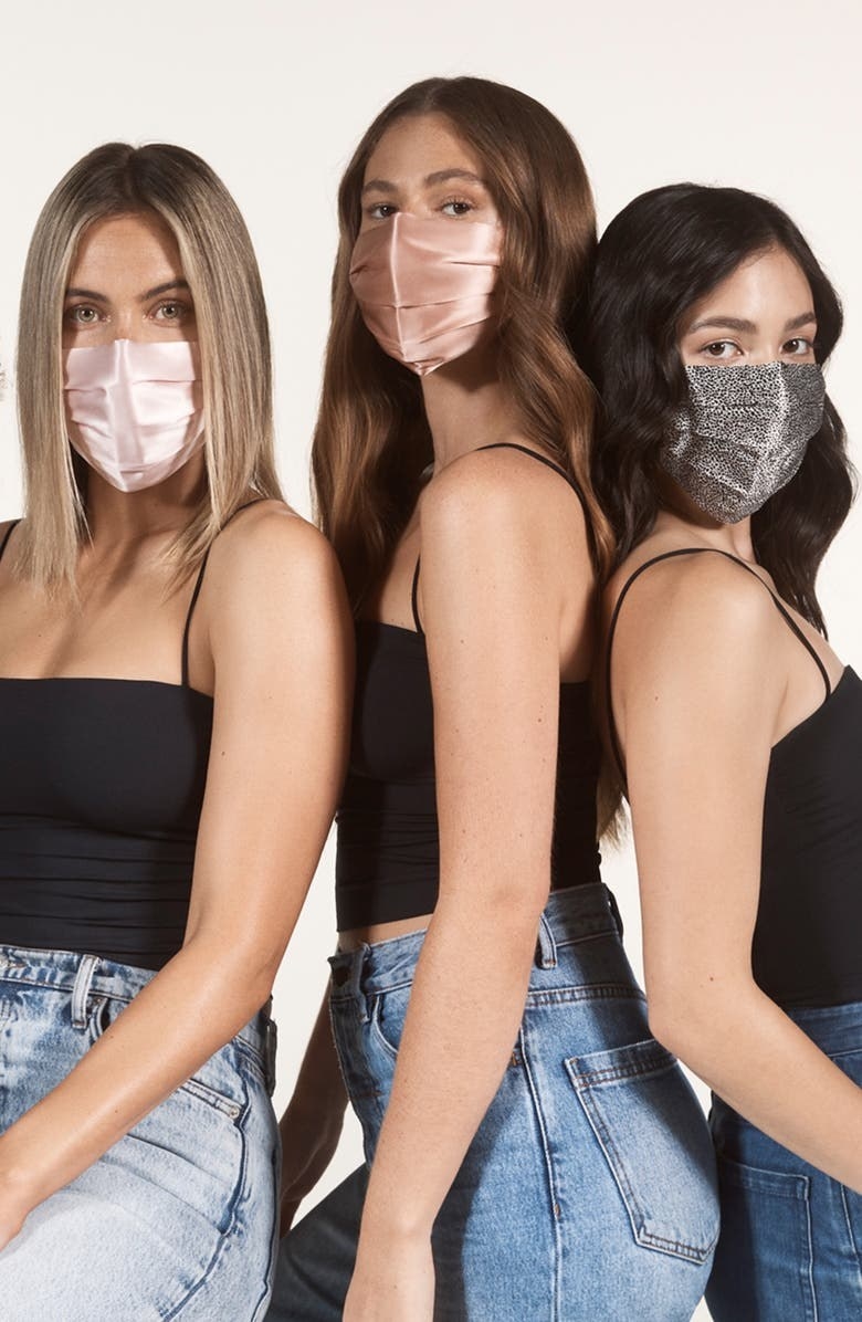 Three models wearing the face covering in different colors