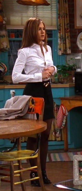 Rachel wearing a button up, a mini skirt, tights and cute shoes
