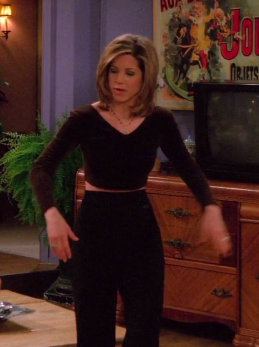 Rachel wearing a long-sleeve crop top and high-waisted pants