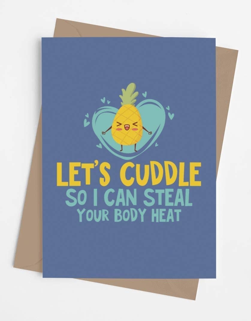 A blue card with a drawing of a pineapple and the words &quot;Let&#x27;s cuddle so I can steal your body heat&quot;