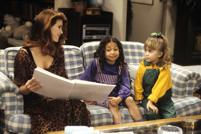 Lori Loughlin, Jurnee Smollett, and Mary-Kate Olsen sitting on couch in the &quot;Full House&quot; living room