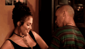 GIF of J.Lo dancing with a man in the video