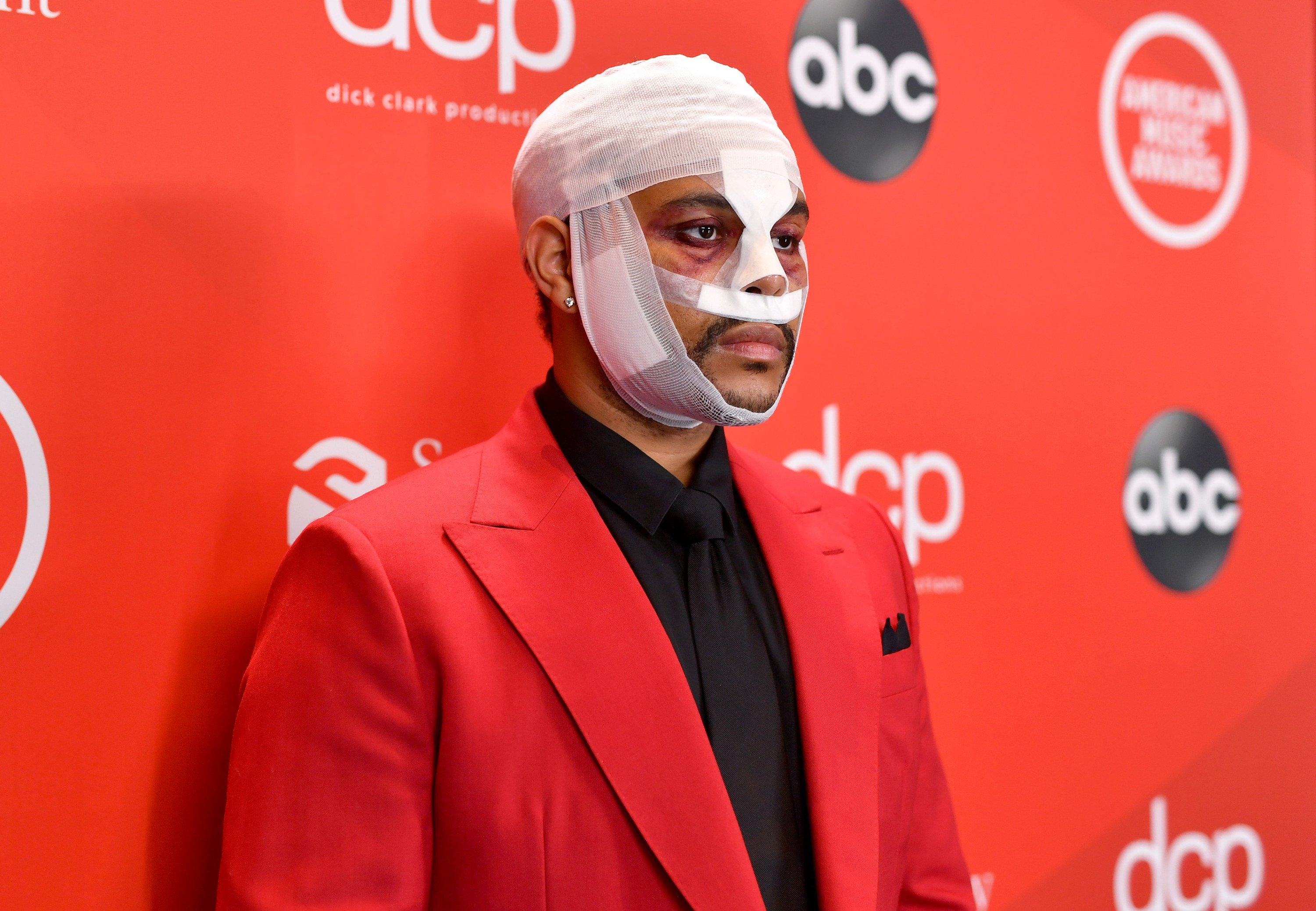 The Weeknd wears face bandages on the red carpet at the American Music Awards