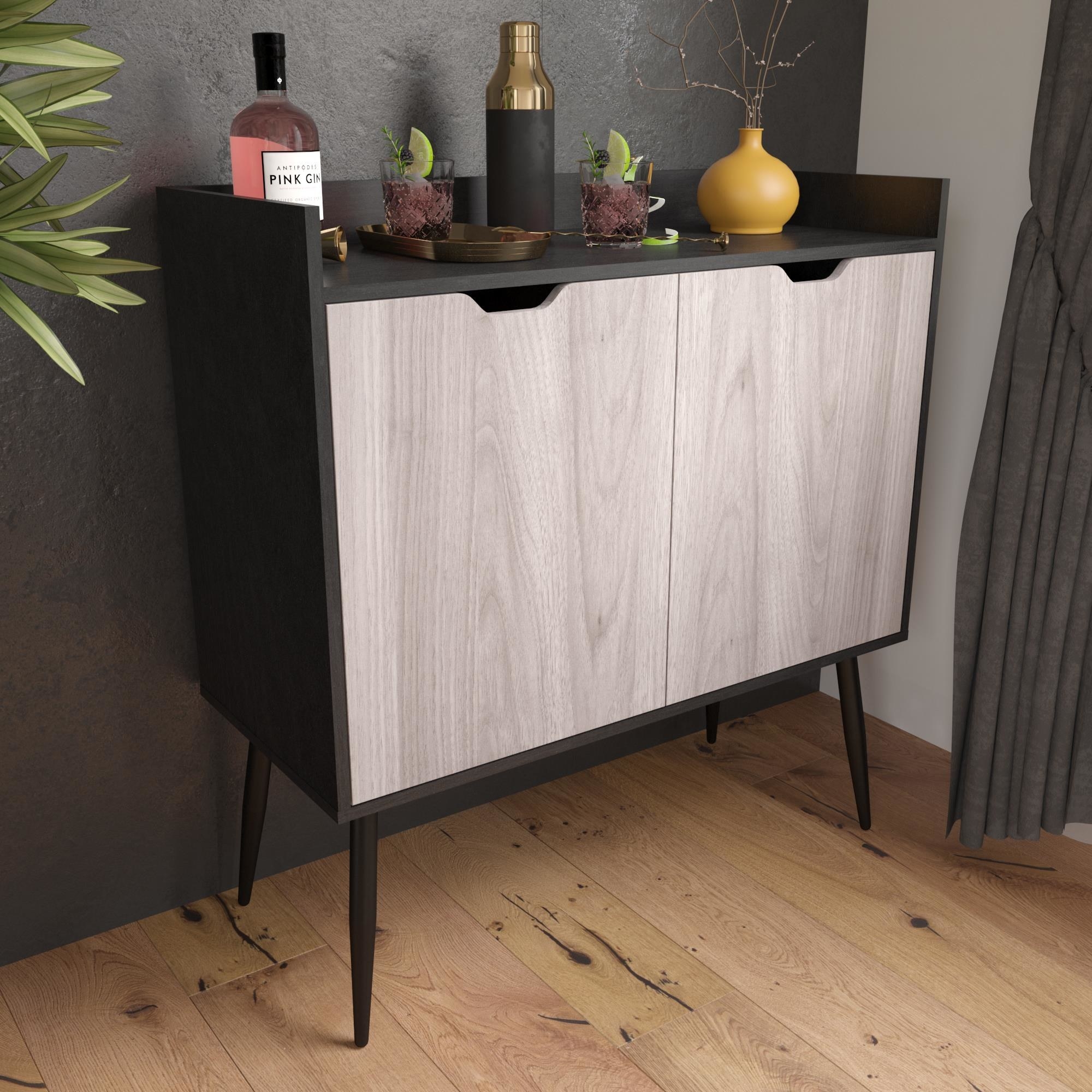 The cabinet, which has two hinged doors that are a light oak color, and a dark body, top, and legs