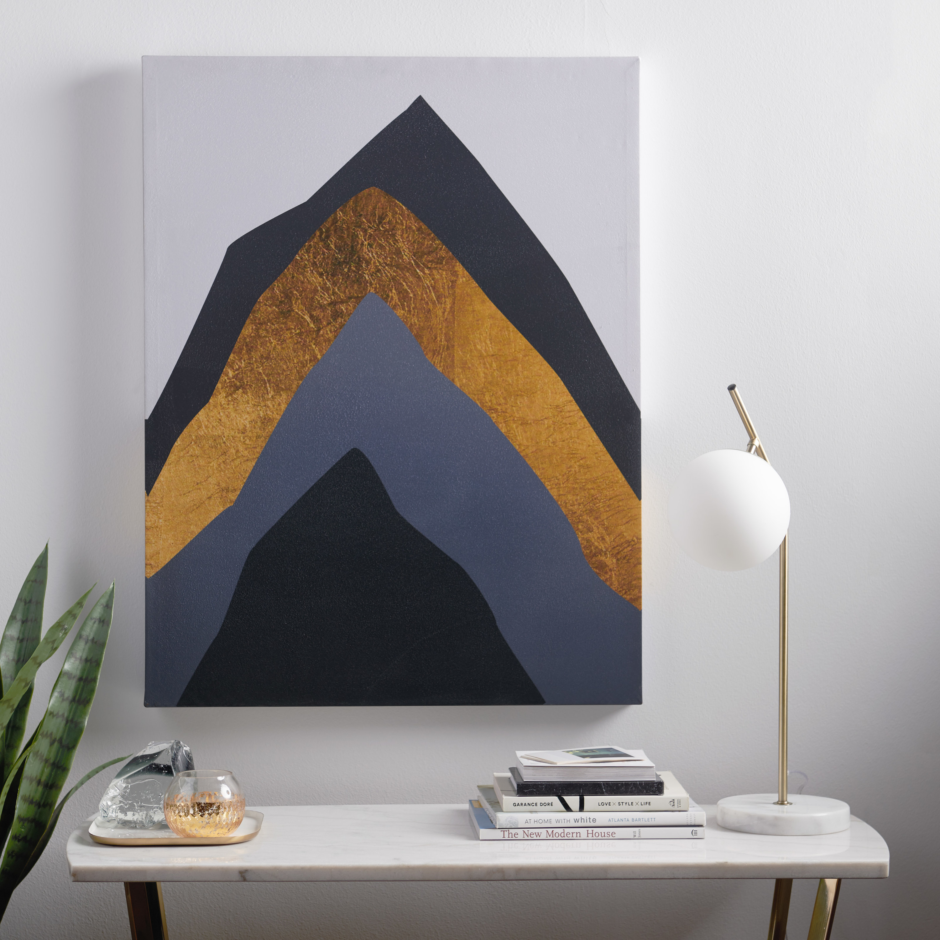 The print, which looks like mountains or a cut-open geode, rendered in black, gray, and gold