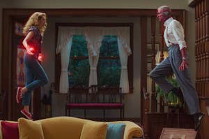 Wanda and Vision floating in the air using their powers, facing off as if to fight